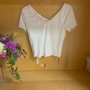 Lettuce trimmed white tee with bow in back